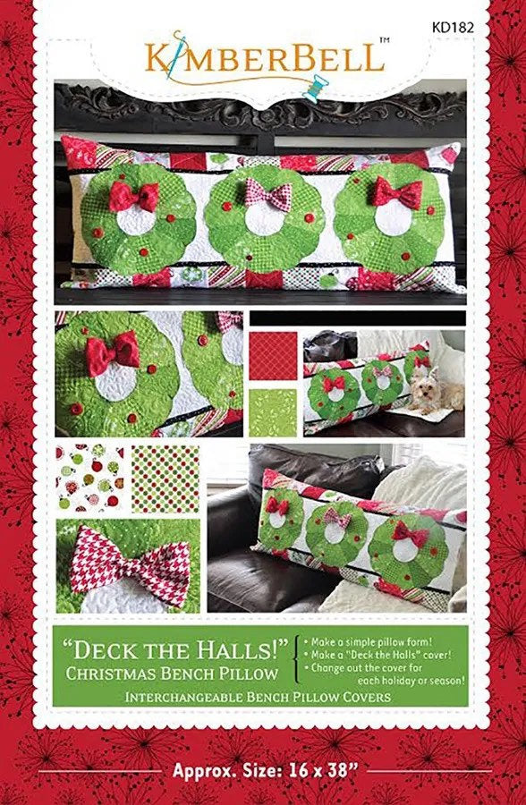 May include: A sewing pattern for a Christmas bench pillow with interchangeable covers. The pattern features a green wreath design with red bows and buttons. The text on the pattern reads 'Deck the Halls!' Christmas Bench Pillow. Interchangeable Bench Pillow Covers. Approx. Size: 16 x 38'.